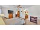 Carpeted main bedroom with ceiling fan and connected wash area with wooden cabinets at 6211 Crane Dr, Lakeland, FL 33809