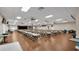 Large meeting hall featuring rows of tables and chairs, ceiling fans, and a stage area at 6211 Crane Dr, Lakeland, FL 33809