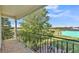 This cozy balcony overlooks green pastures and features decorative metal railings and patterned tile flooring at 6383 Summertimes Plantation Blvd, Bartow, FL 33830