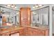 Bathroom featuring dual sinks, wood cabinets, and a vanity area at 6383 Summertimes Plantation Blvd, Bartow, FL 33830