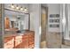 Bathroom featuring wooden cabinets, tiled flooring, and a glass walk-in shower at 6383 Summertimes Plantation Blvd, Bartow, FL 33830