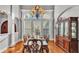 A formal dining room with an elegant chandelier, ample natural light, and a timeless design at 6383 Summertimes Plantation Blvd, Bartow, FL 33830