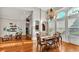 Elegant dining room with hardwood floors, chandelier, and natural light streaming through large windows at 6383 Summertimes Plantation Blvd, Bartow, FL 33830