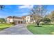 Beautiful home exterior featuring a tile roof, manicured lawn, and three-car garage at 6383 Summertimes Plantation Blvd, Bartow, FL 33830