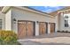 Spacious three-car garage with paneled doors and stylish carriage lamps at 6383 Summertimes Plantation Blvd, Bartow, FL 33830