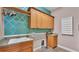 Well-lit laundry room with upper cabinets, sink, and tile flooring at 6383 Summertimes Plantation Blvd, Bartow, FL 33830