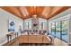 Bright living room with stone fireplace, wood ceiling, and sliding glass doors to patio at 6383 Summertimes Plantation Blvd, Bartow, FL 33830