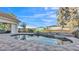 Inviting backyard pool with a spa, lush landscaping, and privacy fence for outdoor enjoyment at 6383 Summertimes Plantation Blvd, Bartow, FL 33830