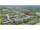 Wide aerial shot showing tree-lined streets and houses surrounding a peaceful body of water at 6515 Eagle View Loop, Lakeland, FL 33813