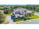 Aerial view of home featuring a tile roof, lush landscaping, and screened-in pool at 6515 Eagle View Loop, Lakeland, FL 33813