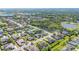 Aerial view shows a neighborhood with tree-lined streets, ponds, and mature landscaping at 6515 Eagle View Loop, Lakeland, FL 33813