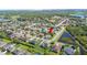 An aerial view displays a residential area with lakes, homes, and tree lined roads at 6515 Eagle View Loop, Lakeland, FL 33813