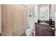 Bathroom featuring a shower with a curtain, vanity with granite countertop, and decorative shelves at 6515 Eagle View Loop, Lakeland, FL 33813