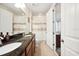 Bathroom with dual vanity, wood cabinets, tub, and a separate shower room at 6515 Eagle View Loop, Lakeland, FL 33813