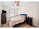 Cozy bedroom with a ceiling fan and light neutral walls, alongside wood-style flooring at 6515 Eagle View Loop, Lakeland, FL 33813