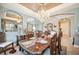 Elegant dining room featuring a chandelier, staircase, and ornate wooden furniture, creating a luxurious dining experience at 6515 Eagle View Loop, Lakeland, FL 33813