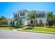 A two-story home with a decorative tile roof, manicured landscaping, and arched entryway at 6515 Eagle View Loop, Lakeland, FL 33813