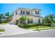 Exterior of a beautiful two-story home with arched windows, brick driveway, and well-maintained landscaping at 6515 Eagle View Loop, Lakeland, FL 33813