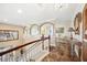 Upstairs hallway area with arched ceilings, tile flooring, and staircase with wood and white railing at 6515 Eagle View Loop, Lakeland, FL 33813