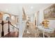 Upstairs hallway area with arched ceilings, tile flooring, and staircase with wood and white railing at 6515 Eagle View Loop, Lakeland, FL 33813