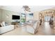 Bright living room with tile floors, ceiling fan, neutral colors, and entry to other rooms at 6515 Eagle View Loop, Lakeland, FL 33813