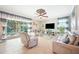 Sunlit living room with tile flooring, a ceiling fan, and view to pool at 6515 Eagle View Loop, Lakeland, FL 33813