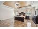 Elegant main bedroom with a decorative ceiling, large bed, and dresser at 6515 Eagle View Loop, Lakeland, FL 33813