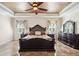 Elegant main bedroom with a decorative ceiling, large bed, and dresser at 6515 Eagle View Loop, Lakeland, FL 33813