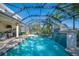 Backyard oasis featuring a sparkling screened-in pool with a waterfall feature. Interior home shot at 6515 Eagle View Loop, Lakeland, FL 33813