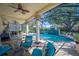 Enclosed pool area with stone columns, turquoise cushions, and a waterfall feature at 6515 Eagle View Loop, Lakeland, FL 33813