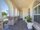 Covered porch featuring brick columns and arched windows, perfect for enjoying the outdoors in comfort at 6515 Eagle View Loop, Lakeland, FL 33813