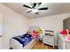 This lovely bedroom is decorated with a Wednesday theme and has a ceiling fan at 6525 Glen Meadow Dr, Lakeland, FL 33810