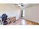 Bright bedroom with wood floors, ceiling fan, and natural light from the window at 6525 Glen Meadow Dr, Lakeland, FL 33810