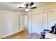 Additional bedroom with a ceiling fan, closet, and hardwood-style floors at 6525 Glen Meadow Dr, Lakeland, FL 33810