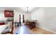 Dining area with modern chandelier, wood table, and open view to the kitchen at 6525 Glen Meadow Dr, Lakeland, FL 33810