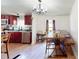 Dining area with modern chandelier, wood table, and open view to the kitchen at 6525 Glen Meadow Dr, Lakeland, FL 33810