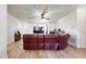 Living room with wood-look flooring and a leather sofa at 6525 Glen Meadow Dr, Lakeland, FL 33810