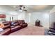 Inviting living room with wood floors, a ceiling fan, and a cozy seating area at 6525 Glen Meadow Dr, Lakeland, FL 33810