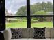 Sunroom view of spacious landscaped backyard from the sunroom sofa at 692 Augusta Rd, Winter Haven, FL 33884