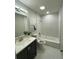 Bright bathroom featuring modern fixtures, a tub with shower, and elegant marble tile surround at 692 Augusta Rd, Winter Haven, FL 33884