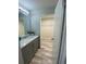 Updated bathroom with a modern vanity and walk-in closet with shelving at 692 Augusta Rd, Winter Haven, FL 33884