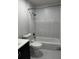 Modern bathroom featuring a shower-tub combo with a white marble tile surround and sleek fixtures at 692 Augusta Rd, Winter Haven, FL 33884
