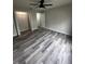Spacious bedroom with modern flooring, a ceiling fan, and an attached closet at 692 Augusta Rd, Winter Haven, FL 33884