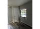 Bright room, view of porch, storage closet, and laminate floors at 692 Augusta Rd, Winter Haven, FL 33884