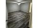 A bright bedroom with a neutral color palette, a ceiling fan and wood-look flooring at 692 Augusta Rd, Winter Haven, FL 33884