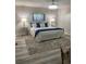 Cozy bedroom with a queen bed, stylish lighting, and a decorative ceiling fan at 692 Augusta Rd, Winter Haven, FL 33884