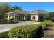 Welcoming clubhouse entrance with covered driveway, lush landscaping, and well-maintained facade at 692 Augusta Rd, Winter Haven, FL 33884