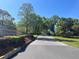 Well-manicured community entrance, highlighted by lush landscaping and mature trees at 692 Augusta Rd, Winter Haven, FL 33884
