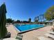 Beautiful community pool surrounded by ample seating and lush landscaping at 692 Augusta Rd, Winter Haven, FL 33884