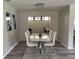 Chic dining area with contemporary table and chairs, showcasing modern lighting and decor at 692 Augusta Rd, Winter Haven, FL 33884